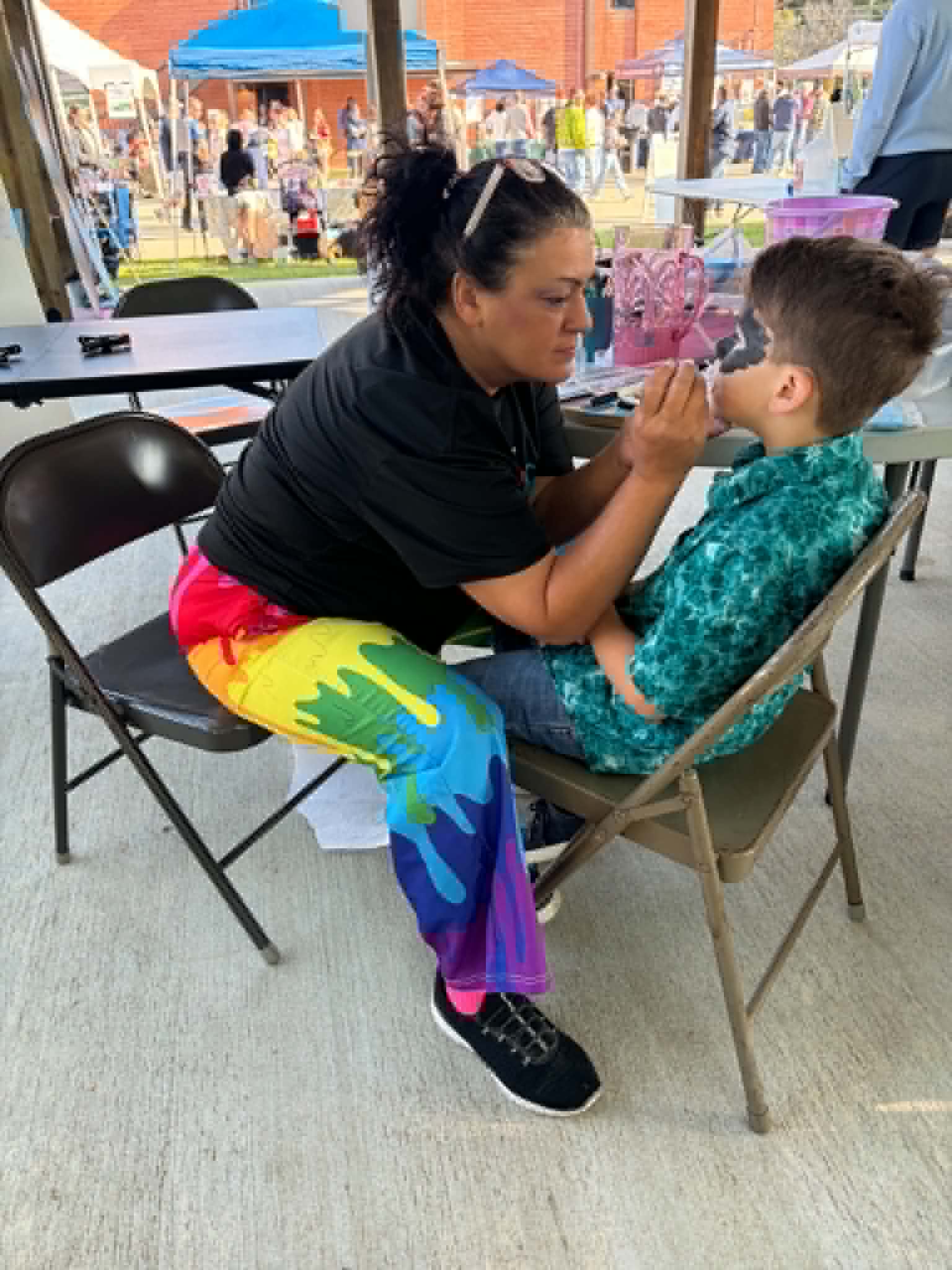 Bridget painting a child's face
