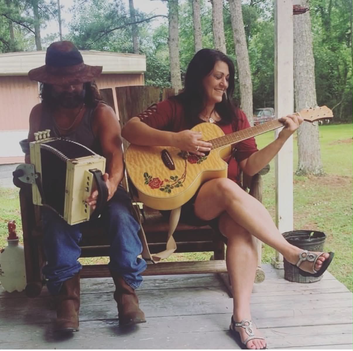 Bridget Campbell LaVergne playing guitar beside an accordion player